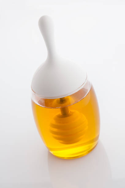 istock jar of honey with honeycomb on white 1723759687