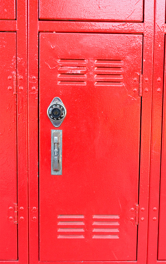 A red locker at a school campus.