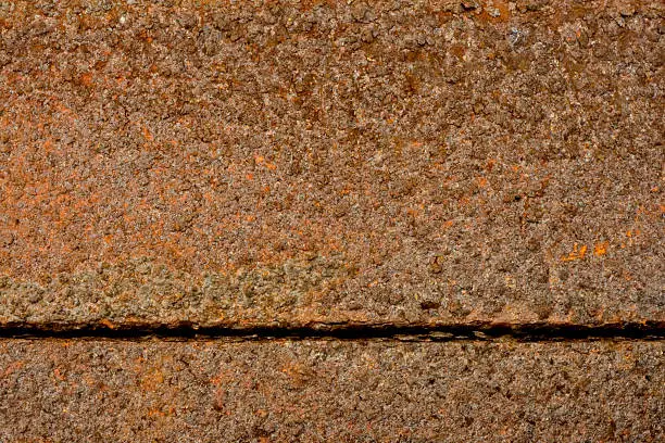 A lot of rust on two metal bars with a horizontal gap between them. Everything is in focus and there is a lot of different colours.Other rusty images in my portfolio: