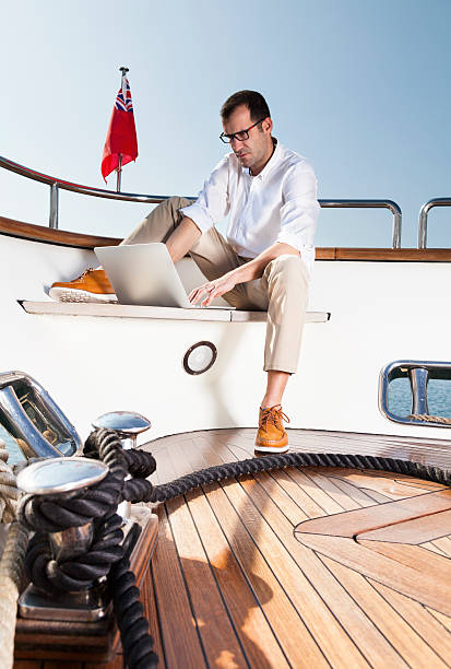 istock Businessman on board of the yacht reading e-mails 172376834