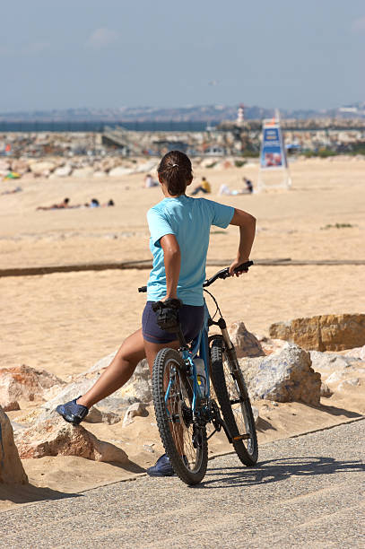 istock Girl with bicycle at the beach 172377373