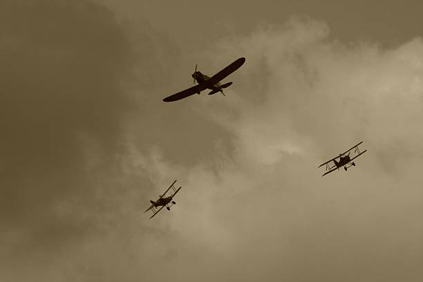 Stormy sky of the WWI dogfight in sky WWI dogfight in sepia. airshow photos stock pictures, royalty-free photos & images