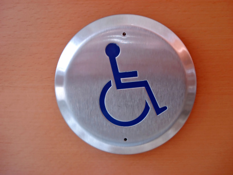 Wheelchair access symbol; push button to open a door