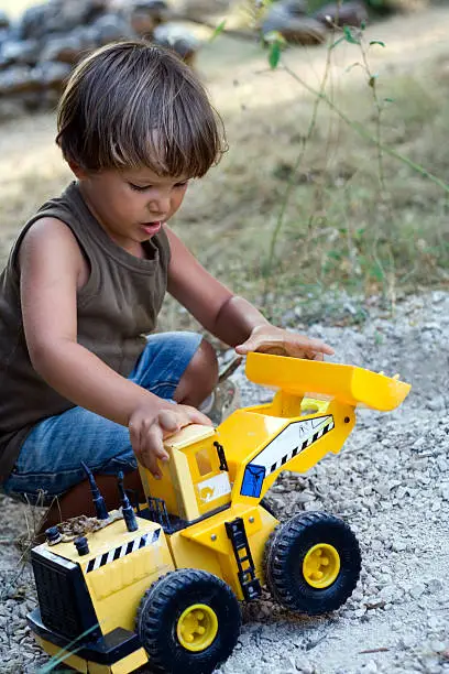 A Child Playing with a Toy Car
