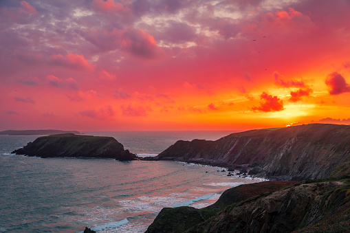 Sunset from the cliff tops of Marloes Sands during high tide on the Pembrokeshire coast south west Wales UK