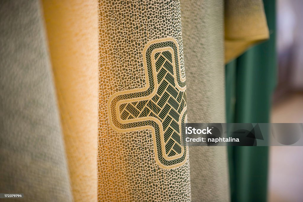 Priest frock detail on a cross over a priest frock. Authority Stock Photo