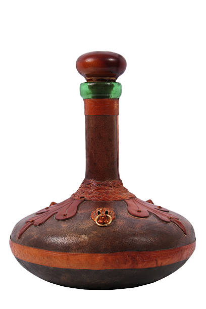 Genie's bottle Old decanter in leather on white background. potion bottle retro revival old fashioned stock pictures, royalty-free photos & images
