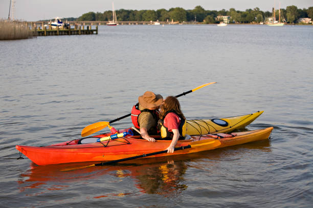 Kayak Kiss Outdoorsy couple takes a break from kayaking for a little kiss chestertown stock pictures, royalty-free photos & images