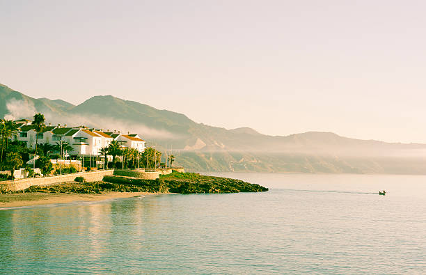 Sunrise at the coast of Nerja . Cross processed picture.