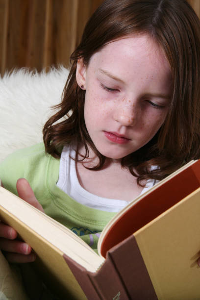 istock Little Girl Reading 172382103