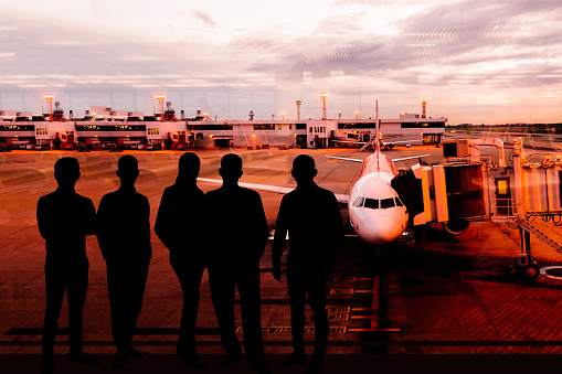 Happy businessman waiting for flight in airport Silhouette of a businessman