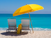 Yellow Umbrella and deck chairs South Beach Miami