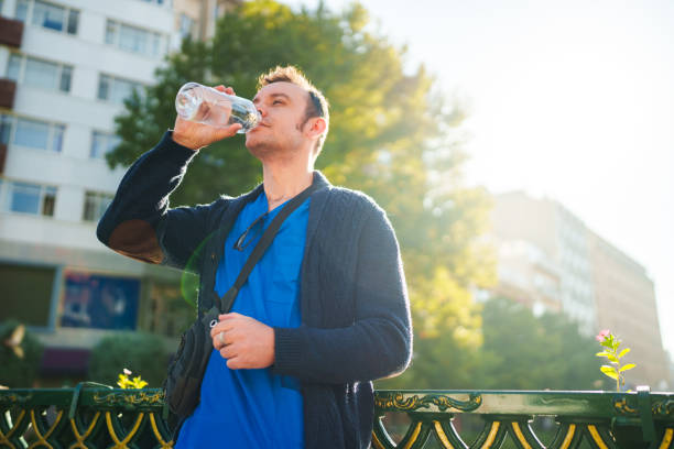 istock Healthcare worker drinking water from reusable water bottle. 1723826572