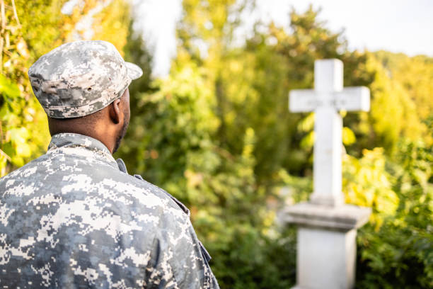 istock Soldier at cemetery on Memorial Day. 1723835125