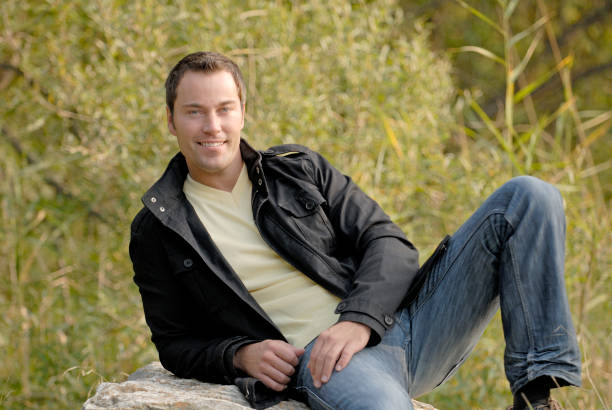 istock happy man sitting on a rock 172383533