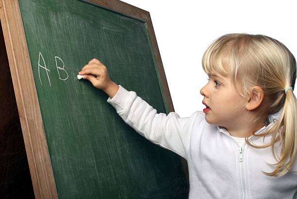 istock Little girl writing ABC alphabet on a blackboard 172383677
