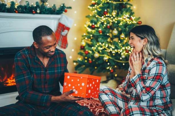istock Young couple celebrating Christmas at home 1723843673