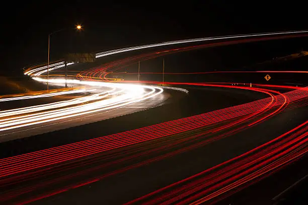 Light trails created along an S-curve of a freeway