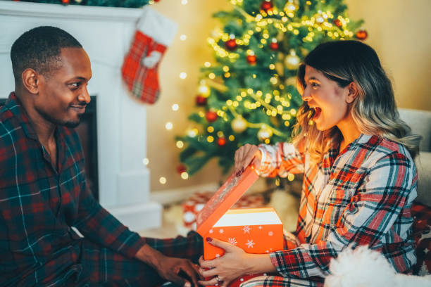 istock Young couple celebrating Christmas at home 1723845246