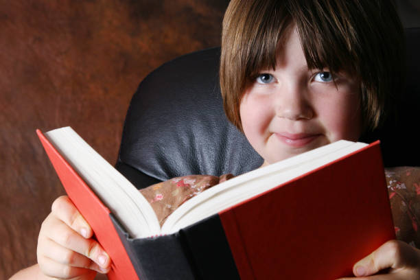 istock Young Girl Reading A Red Book 172384580
