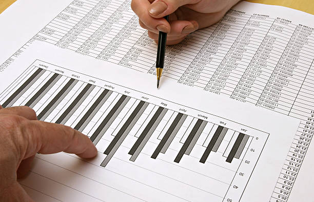 istock Close-up of financial graphics being pointed by men's hands 172384749