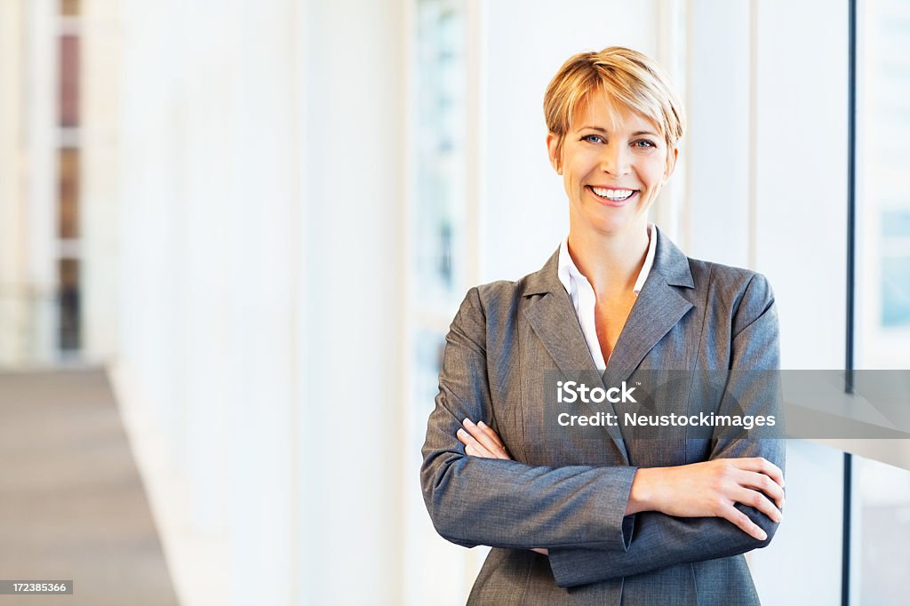 Businesswoman Standing With Arms Crossed Portrait of happy mid adult businesswoman standing with arms crossed. Horizontal shot. 30-39 Years Stock Photo
