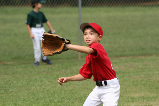 a boy trying to catch a baseball