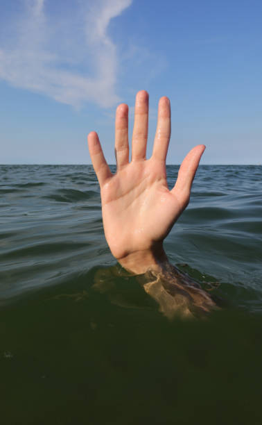 istock hand while drowning in the ocean and asking for help symbol of failure and failure 1723863718