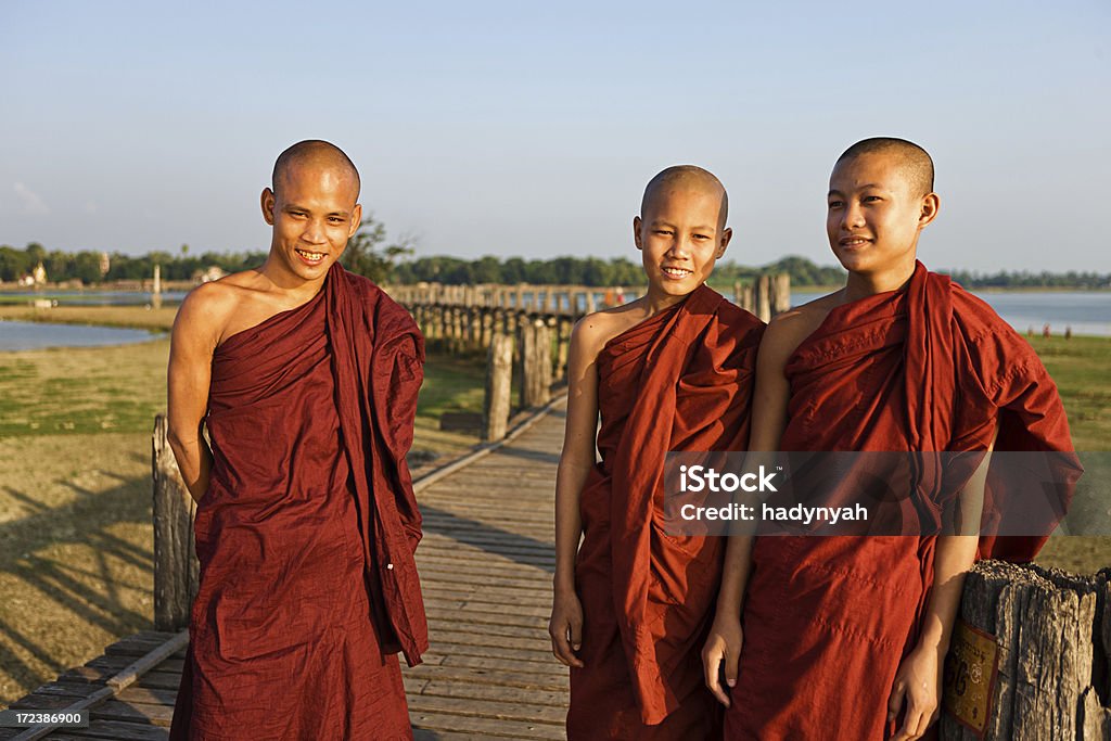 Buddhist Monks crossing U Bein Bridge "Portrait of a Buddhist Monks crossing U Bein Bridge, Myanmar (Burma)" Adult Stock Photo