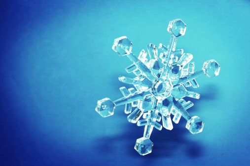 Crystal snowflake on dramatic blue background.