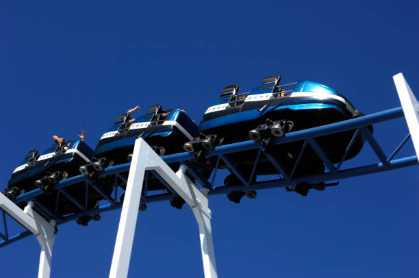 istock Roller Coaster ride on tracks up high with blue sky. 172387190