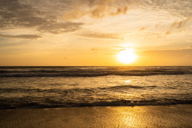 istock Colorful ocean beach sunset, Orange and golden sunset sky. 1723875006