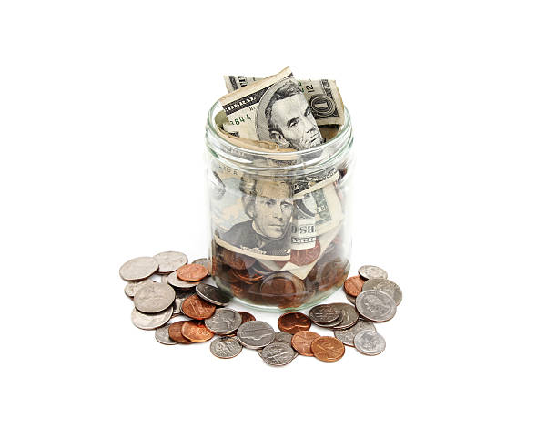 istock Jar of coins and currency 172387535