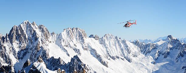 Rescue helicopter in Alps Rescue helicopter flying over Alps mont blanc massif stock pictures, royalty-free photos & images