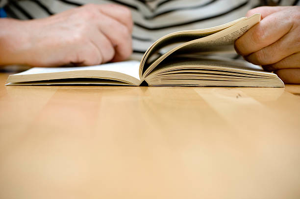 istock Senior woman reading a book 172387880