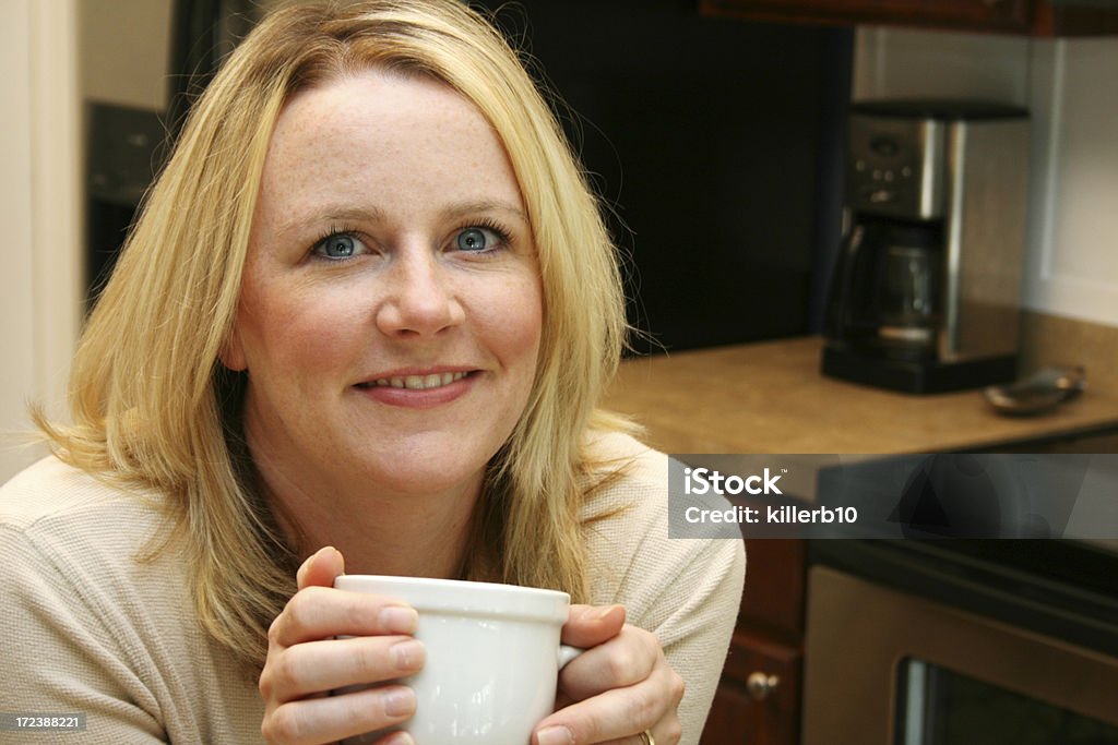 Coffee Break Woman enjoys a hot cup of coffee in the kitchen 25-29 Years Stock Photo