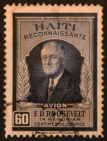 old yellowed postage stamp from Haiti honoring Franklin Roosevelt.