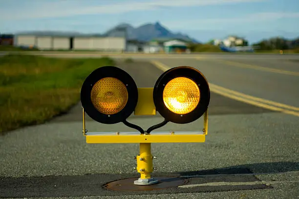 Warning lights telling aircraft that the runway is just ahead. This light is alternating between left and right. This image shows light in the right one.See my similar images: