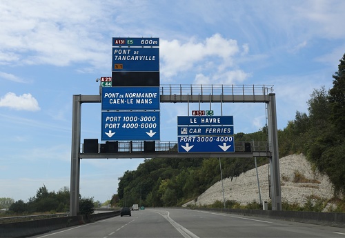 road signs with French locations on the wide motorway with directions to reach the port of le HAVRE