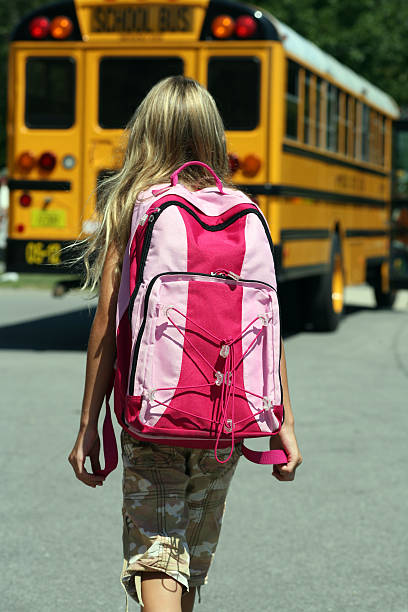 istock Back to School - Girl walking toward Bus 172389891