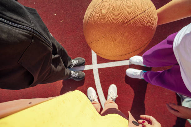 Outdoor Unity: Teenagers Find Balance and Skill on the basketball court stock photo