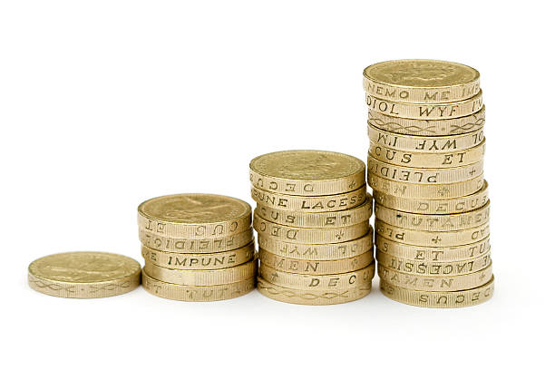 Stacks of thick coins with writing inscribed to their edges stock photo