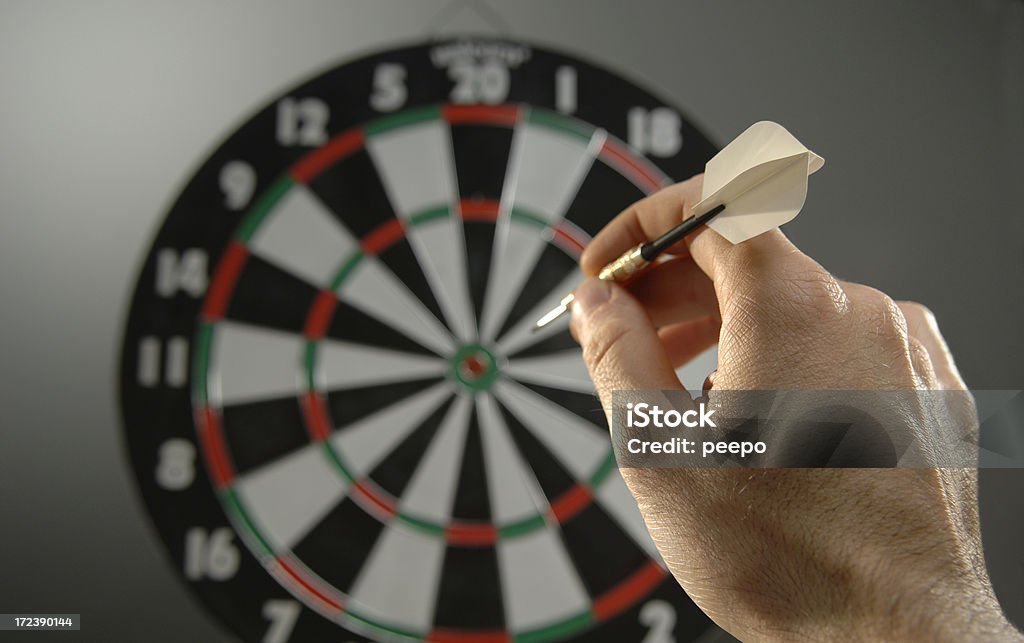 darts series shallow depth of field shot of hand about to throw dart into board Darts Stock Photo