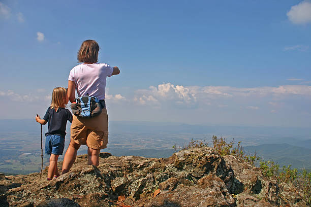 Mother/women with young child hiking on top of the mountains "Mother and 4 year old daughter on top of Shenandoah National Park. Looking down to Shenandoah River Valley. Virginia, USA" shenandoah national park photos stock pictures, royalty-free photos & images
