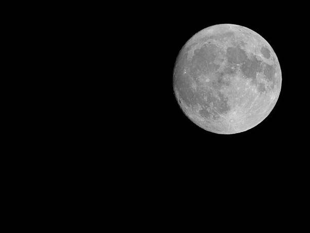 huge very bright silvery super moon and you can also see the lunar craters with black sky