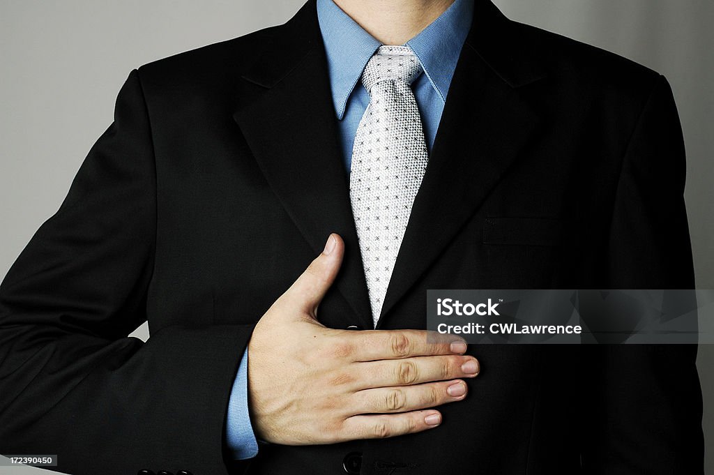 hand over torso business man with hand across his torsoMore images of this Businessman: Adult Stock Photo