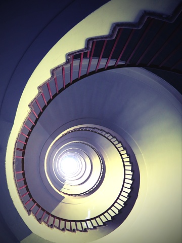 almost hypnotic effect of a spiral staircase that rises upwards without people with an antique effect