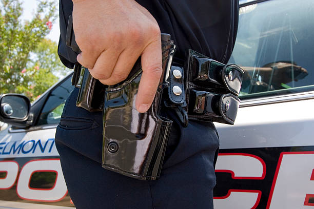 istock policeman at car with gun 172390992
