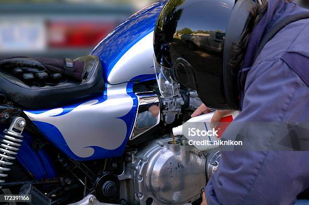 Motorcyclist Adding Oil Stock Photo - Download Image Now - Biker, Crash Helmet, Crude Oil