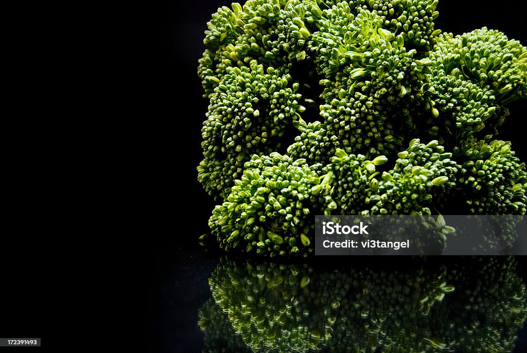 Broccollini Reflection broccolini on black background Antioxidant Stock Photo